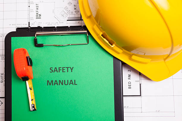 istock Construction:  Safety manual and workman's tools on houseplans. 186735878