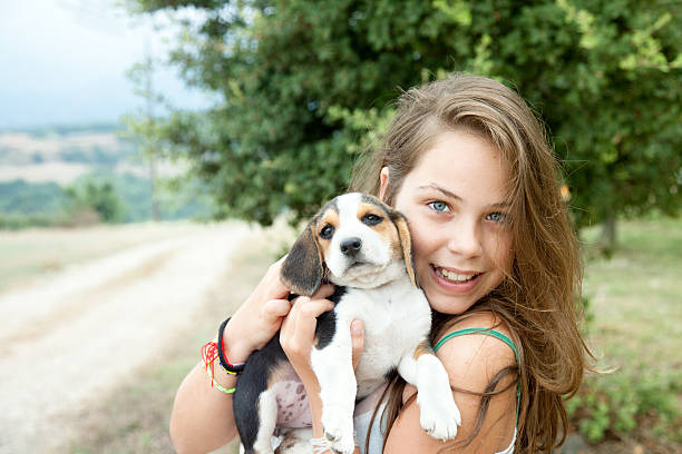 istock Girl and puppies 186735910
