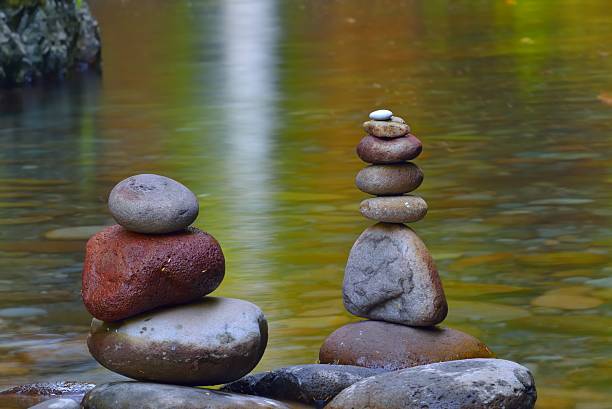 istock stacked stones on tranquil zen lake 186736193