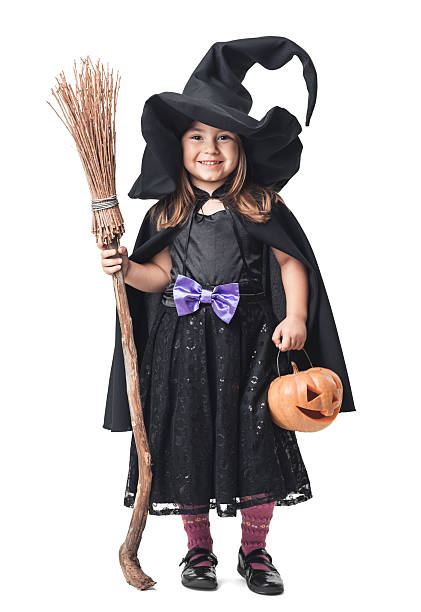 istock little witch with a broom and pumpkin 186737382
