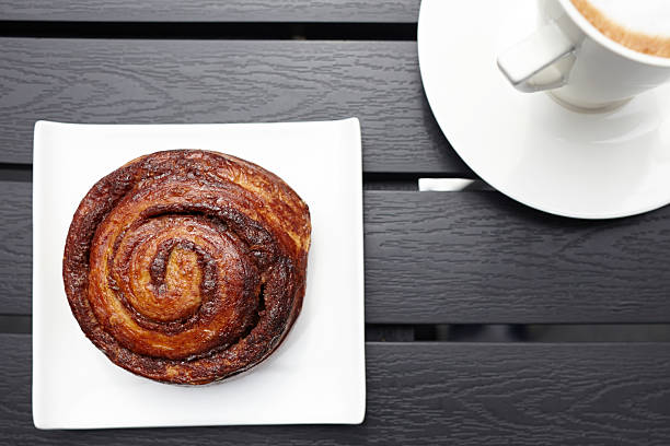 istock Danish pastry on table with cappuccino cup top view 186737460