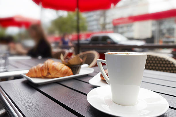 istock Cappuccino drink with croissant muffin pastry on table 186737467
