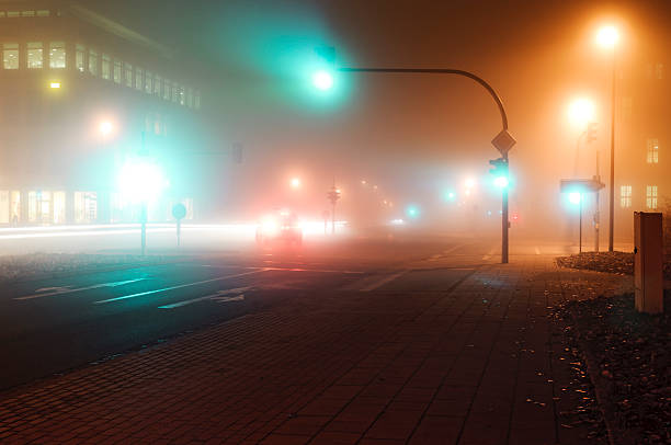 istock Traffic on a foggy intersection 186737796