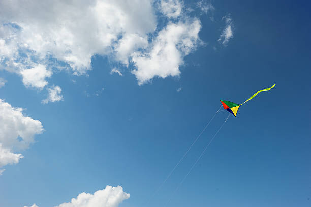istock Rainbow kite flies in the sky among clouds 186739106