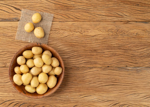istock Tiny potatoes in a bowl over wooden table with copy space 1867398957