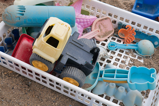 Die-cut toys to play with in a worn-out sandbox