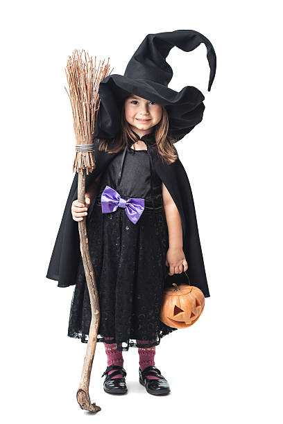 istock little witch with a broom and pumpkin 186741236