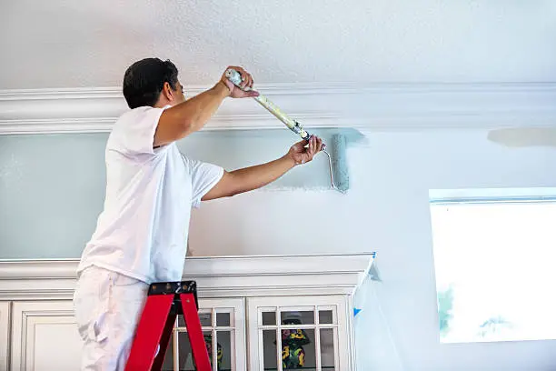 Photo of House painter painting residential home interior