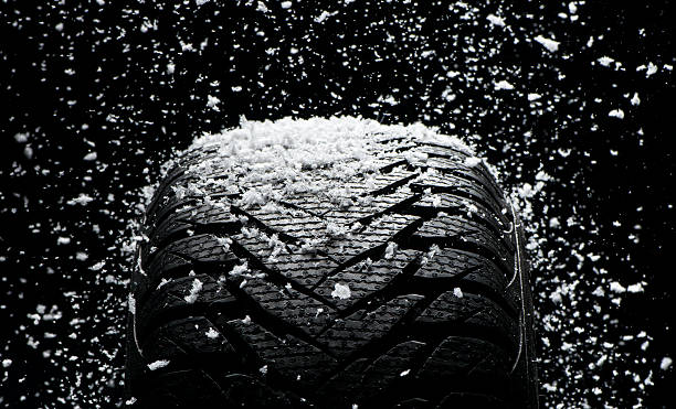 istock New tire covered with snow 186741768