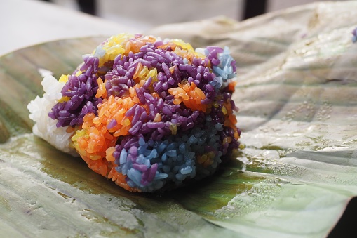Close up of ball of colored sticky rice on a leaf – Vietnamese street food