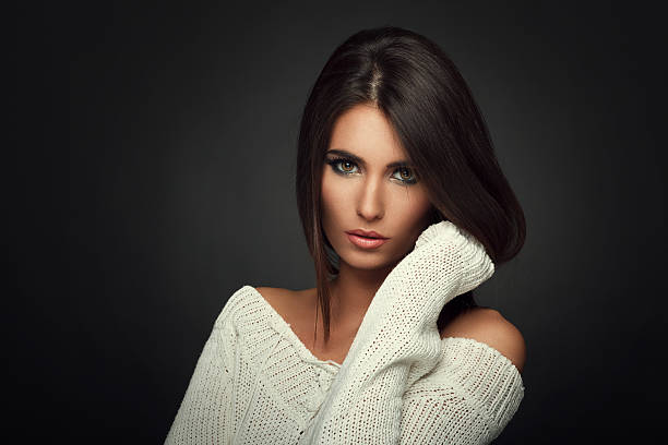 beautiful girl in white suit sitting on chair on textured background
