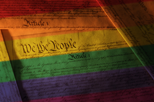 Rainbow flag colors on the US Constitution -- gay and equal rights concept