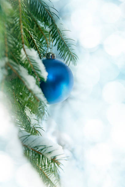 istock Blue Baubles On Snowy Christmas Tree 186744854