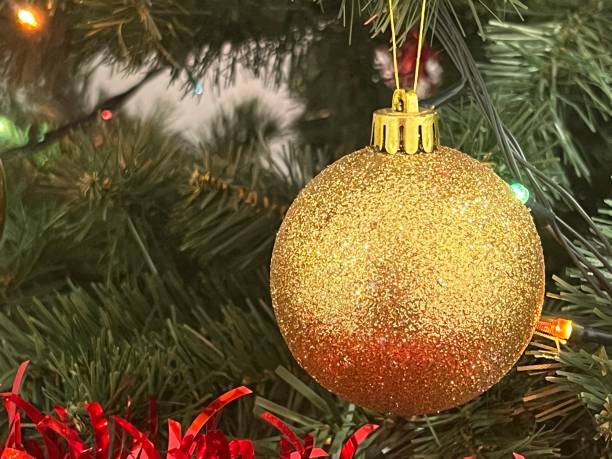 istock festive Christmas ornament hanging on tree branches 1867449354