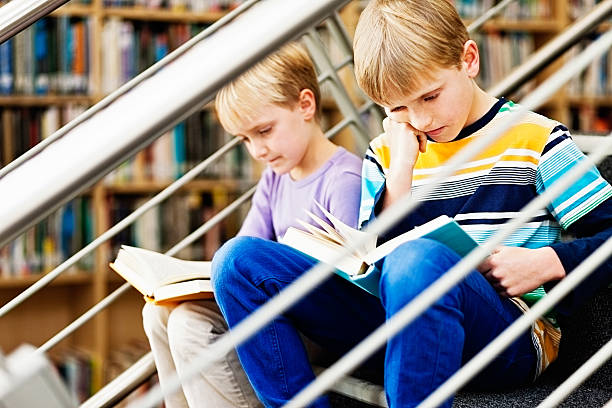 istock Rainy day activity: contented brother and sister reading in library 186745784