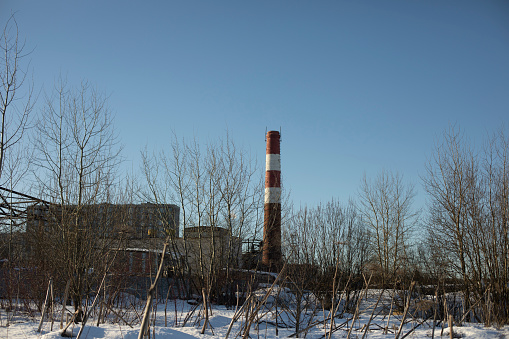 Industrial zone in winter. Boiler station pipe. Heating station on the edge of the city. Big Pipe Plant.