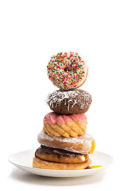 istock Decorated donuts stacked on white plate-isolated on white 186746081