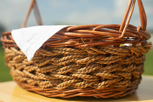 Wicker basket. Rustic subject. Beautiful harvest basket. Folk craft.