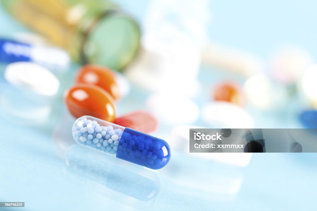 Pill close up Close up of pill with other pills in background. This file is cleaned and retouched. Acid Stock Photo