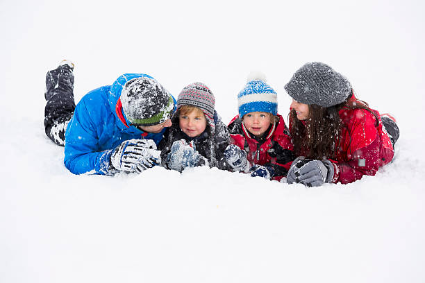 istock Happy family having fun in snow 186746342