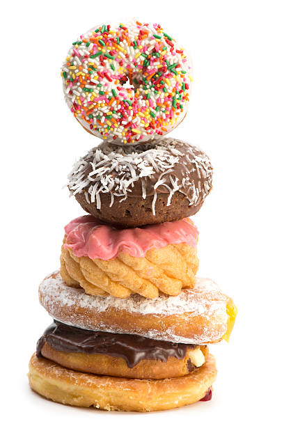 istock Six decorated donuts stacked-isolated on white-close up 186746584