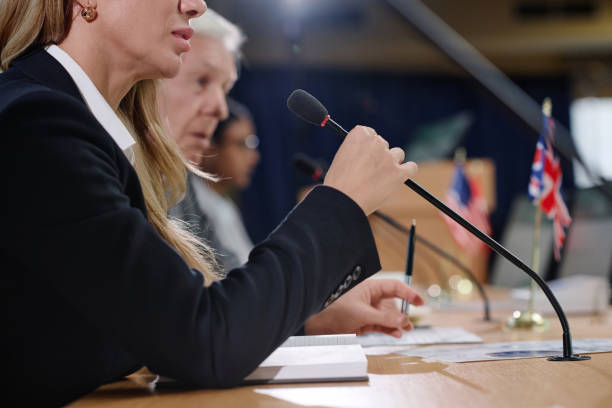 istock Woman speaking in microphone at conference 1867472009