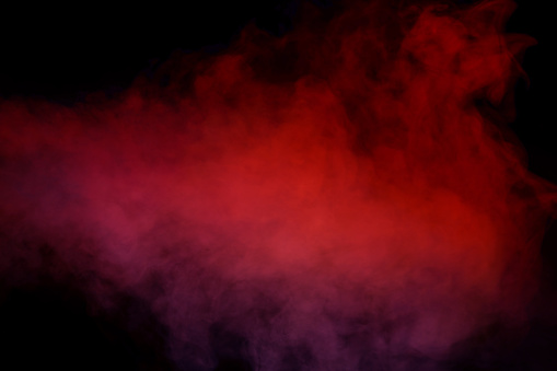 Orange and red steam on a black background. Copy space.