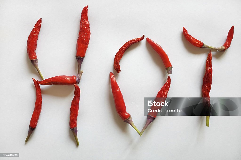 Hot chili peppers Twelve fresh hot chili peppers disposed to form the HOT word Food Stock Photo
