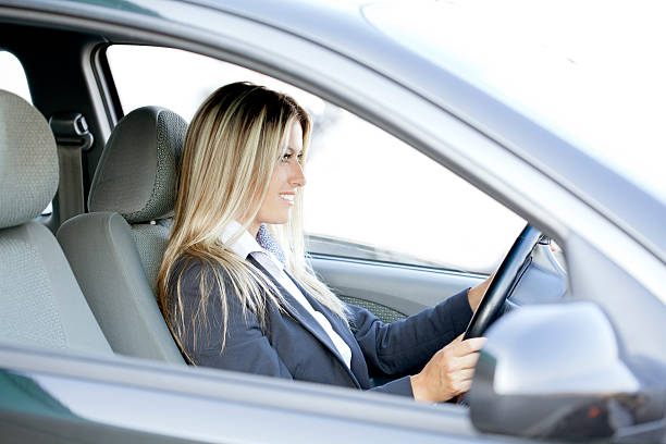 istock young woman driving car 186748598