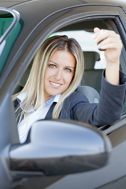 istock happy woman with new car 186748603
