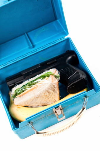 Handgun in lunchbox, Conceptual image for guns in schools/ School shootings.