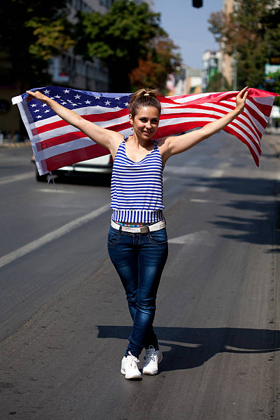 istock young woman with USA flag 186749126