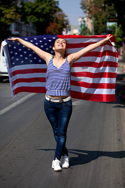 istock young woman with USA flag 186749127