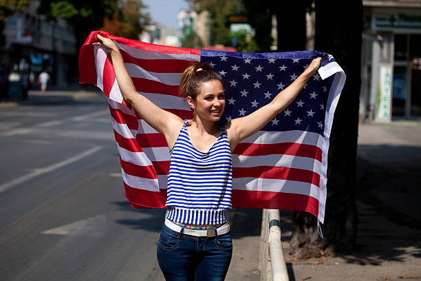 istock young woman with USA flag 186749130