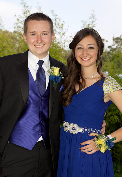 Prom Couple Smiling Outdoors Blue Dress An attractive prom couple smiling and posing outdoors. prom photos stock pictures, royalty-free photos & images