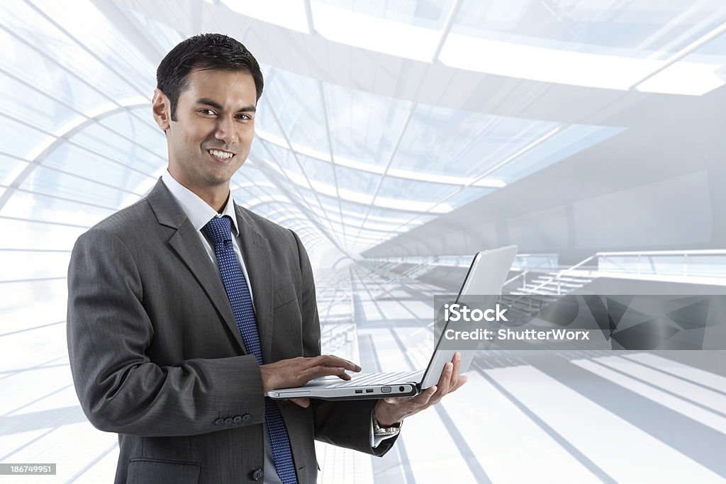 Working In The Office Handsome Asian Businessman Working On His Laptop In The Office. 140 More Shots Of This Popular Model In Both Vertical & Horizontal Business Settings: Adult Stock Photo