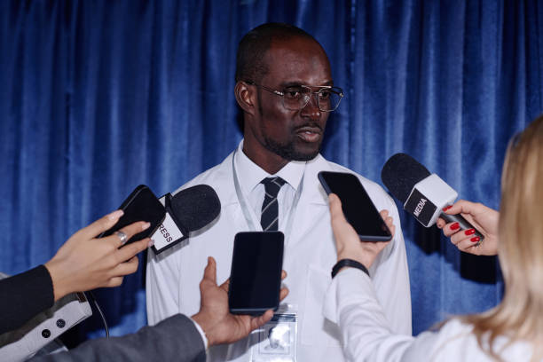istock Doctor giving an interview to journalists 1867500808