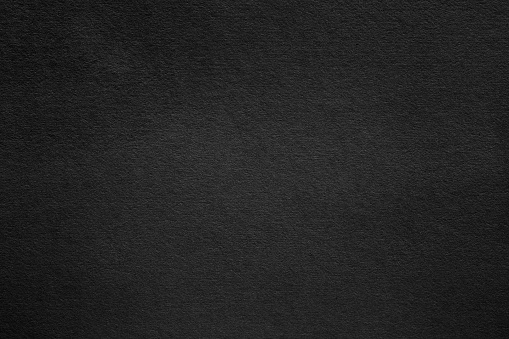 Black paper surface with grainy texture