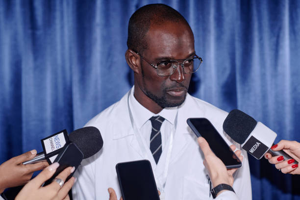 istock Doctor talking to journalists at press conference 1867502382