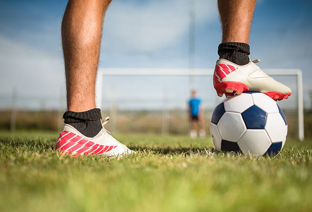 istock soccer player with his ball 186750437