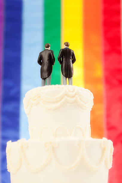 istock Gay Wedding Cake, Two Men Topper with Rainbow Flag Background 186750524