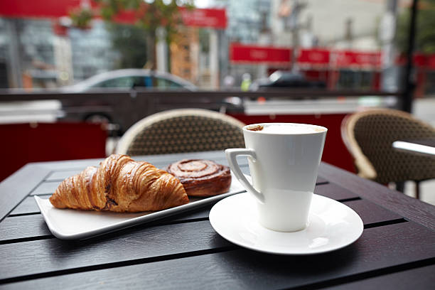 istock Croissant danish pastries with cappuccino drink on table 186750635