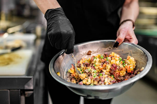 istock Professional chef cooking Salad Olivier in restaurant kitchen 1867507620