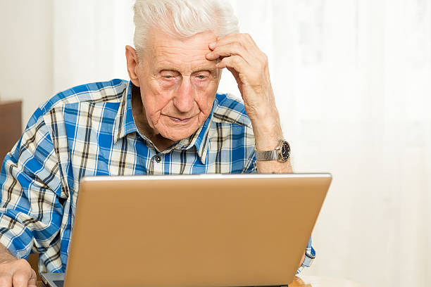 istock Senior man in front of a laptop computer 186750874