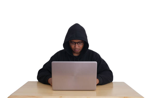 istock A hacker wearing a hoodie and goggles is hacking into his victims' financial systems. Gray background. Data thief, internet fraud, darknet and cyber security concept. 1867509222