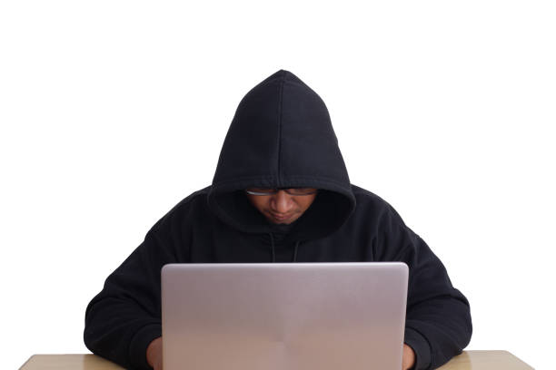 istock A hacker wearing a hoodie and goggles is hacking into his victims' financial systems. Gray background. Data thief, internet fraud, darknet and cyber security concept. 1867509225