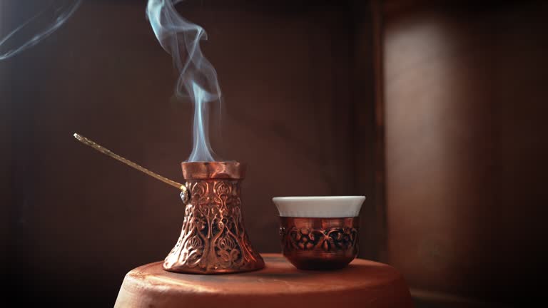 Steamy Turkish Coffee pot known as Cezve or Jezve and coffee cup