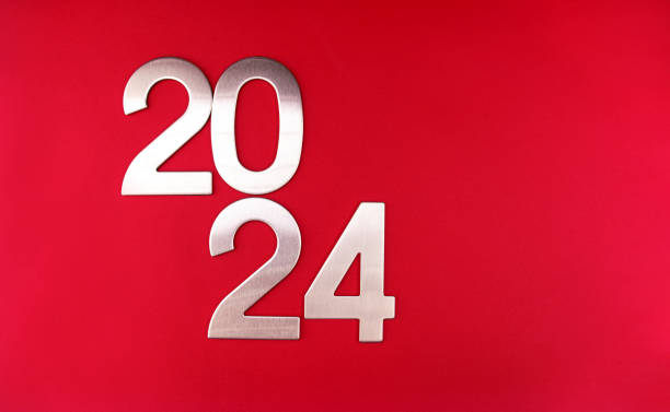 istock Composition with the number 2024 in silver, metal on a red monochrome background 1867533399