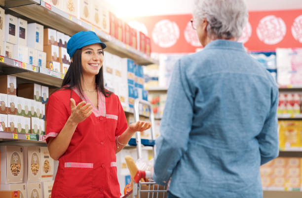 istock Supermarket clerk helping a senior customer 1867534438