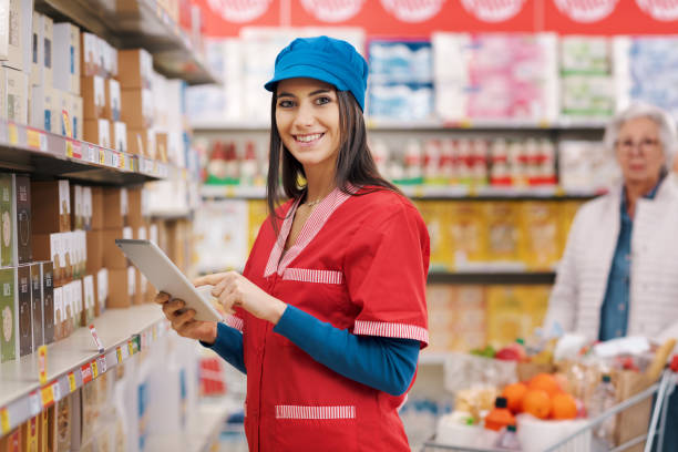 istock Confident grocery clerk working at the supermarket 1867539762